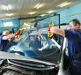 Collision experts replacing car windshield